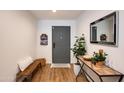 Entryway features a bench, console table with décor, mirror, and gray front door at 4932 E Kathleen Rd, Scottsdale, AZ 85254