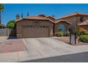 Inviting home features a two-car garage and low-maintenance landscaping at 5952 E Phelps Rd, Scottsdale, AZ 85254