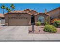 Attractive home featuring a spacious driveway and colorful, desert-friendly landscaping at 5952 E Phelps Rd, Scottsdale, AZ 85254