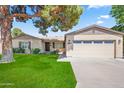 Well-maintained single-story home with a two-car garage and lush green lawn at 6819 N 10Th Pl, Phoenix, AZ 85014
