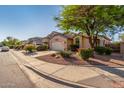 Well-maintained home with desert landscaping, complemented by a spacious two-car garage at 80 W Grey Stone St, San Tan Valley, AZ 85143