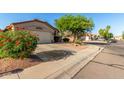 Beautiful desert landscaped home with a spacious driveway and well-manicured curb appeal at 80 W Grey Stone St, San Tan Valley, AZ 85143