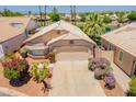 Well-maintained home features a two-car garage, desert landscaping and a tile roof at 10526 W Tonopah Dr, Peoria, AZ 85382