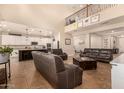 Open-concept living area connects to the kitchen, featuring high ceilings, ample seating, and tile flooring throughout at 10718 E Vivid Ave, Mesa, AZ 85212