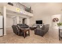 Comfortable living room showcases a soaring ceiling, a wrought iron railing, and an open layout perfect for relaxation and gatherings at 10718 E Vivid Ave, Mesa, AZ 85212