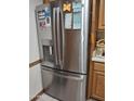 Close-up of a modern, stainless steel refrigerator with a water dispenser and ice maker, adding a touch of elegance at 10721 W Mission Ln, Sun City, AZ 85351