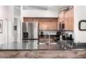 Modern kitchen featuring stainless steel appliances, granite countertops and wood cabinets at 1120 N Val Vista Dr # 113, Gilbert, AZ 85234