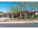 Charming single-story home featuring mature desert landscaping, a two-car garage and neutral exterior at 12366 N 129Th St, Scottsdale, AZ 85259