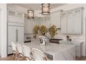 Open kitchen with white cabinets, oversized island, and stainless steel appliances at 12366 N 129Th St, Scottsdale, AZ 85259