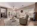 Comfortable living room with tiled floors, plush seating, and a view of the outdoor space at 1325 E Linda Dr, Casa Grande, AZ 85122