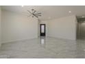 Bright living room with high ceilings, recessed lighting, and tile floors throughout at 13430 S Garnet Rd, Buckeye, AZ 85326