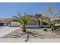 Inviting home featuring desert landscaping, a charming facade, and a well-maintained front yard with mature palm at 15655 W Berkeley Rd, Goodyear, AZ 85395