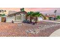Attractive single-story home featuring desert landscaping, a front courtyard, and a well-manicured lawn at 15825 N 45Th St, Phoenix, AZ 85032
