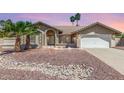 Charming home with well-maintained desert landscaping, a two-car garage, and a welcoming front entrance at 15825 N 45Th St, Phoenix, AZ 85032