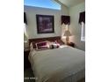 A cozy main bedroom featuring natural lighting, decor and plush bedding for a comfortable living space at 17200 W Bell Rd # 1279, Surprise, AZ 85374