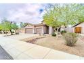 This beautiful home features a three-car garage, desert landscaping, and a spacious driveway at 18633 W Mcneil St, Goodyear, AZ 85338