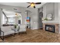 Inviting living room featuring a stone fireplace, plank floors and an open layout at 20239 N 39Th Dr, Glendale, AZ 85308