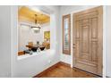 Elegant foyer featuring hardwood floors, a stylish front door, and a view of the adjacent dining room at 2103 E Canyon Pl, Chandler, AZ 85249