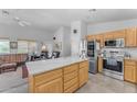 Bright kitchen featuring stone countertops, stainless steel appliances, lots of cabinet space and island at 22609 S 214Th Way, Queen Creek, AZ 85142