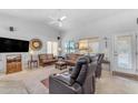 Cozy living room with neutral walls, ceiling fan, and windows to let in light and fresh air at 22609 S 214Th Way, Queen Creek, AZ 85142
