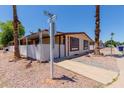 Corner lot featuring desert landscaping, carport, and welcoming curb appeal, perfect for easy living at 245 S 56Th St # 135, Mesa, AZ 85206