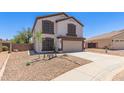 Charming two-story home with a well-manicured front yard and a two-car garage, painted in neutral colors at 33287 N Windmill Run, San Tan Valley, AZ 85144