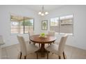 Bright breakfast nook with round table, four chairs, and large windows offering natural light at 3361 E Wisteria Pl, Chandler, AZ 85286