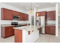 Modern kitchen featuring stainless steel appliances, granite countertops, and a spacious center island at 3361 E Wisteria Pl, Chandler, AZ 85286