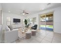 Bright living room with tile floors, stylish furniture, ceiling fan and sliding glass doors to the backyard at 3361 E Wisteria Pl, Chandler, AZ 85286