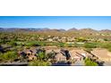 Scenic aerial view of a community with golf course and mountain views at 40619 N Candlewyck Ln, Phoenix, AZ 85086