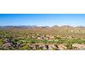 Scenic aerial view of a community with golf course and mountain views at 40619 N Candlewyck Ln, Phoenix, AZ 85086