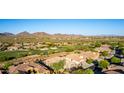 Scenic aerial view of a community with golf course and mountain views at 40619 N Candlewyck Ln, Phoenix, AZ 85086