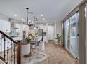 Open-concept kitchen and dining area with stainless steel appliances, island, and sliding glass doors at 4332 E Boston St, Gilbert, AZ 85295