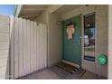 Inviting front entrance featuring a decorated teal door, a welcome mat, and a Central Security Group sign at 4502 W Continental Dr, Glendale, AZ 85308