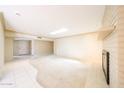 Bright living room with fireplace, tile entry, neutral carpet, and skylight for natural light at 4516 E Willow Ave, Phoenix, AZ 85032