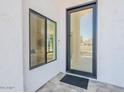 Elegant home entrance featuring a modern glass door and sleek, contemporary design at 4748 E Redfield Rd, Phoenix, AZ 85032