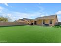 A spacious backyard with a well-maintained lawn and patio, great for outdoor activities at 48069 N Rico Way, Gold Canyon, AZ 85118