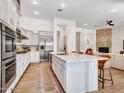 Spacious kitchen boasts white cabinetry, stainless steel appliances, large island, and seamless flow to the living area at 4935 W Lariat Ln, Phoenix, AZ 85083