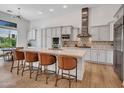 Bright kitchen featuring white cabinets, stainless steel appliances, a large island, and stylish bar stools at 4935 W Lariat Ln, Phoenix, AZ 85083