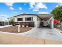 Exterior home view displaying well kept flower beds, front parking, and covered walkway at 5534 E Player Pl, Mesa, AZ 85215
