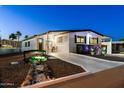 Charming manufactured home featuring a landscaped front yard with walkway and an inviting covered porch area at 5534 E Player Pl, Mesa, AZ 85215