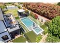 Aerial view of the property featuring a backyard pool, waterfall, and pristine landscaping at 6196 E Calle Camelia --, Scottsdale, AZ 85251