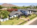 Stunning aerial view of a modern farmhouse-style home with manicured lawn and lush landscaping at 6196 E Calle Camelia --, Scottsdale, AZ 85251