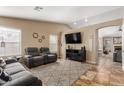 Cozy living room with vaulted ceilings, tile flooring, neutral walls, modern furnishings, and lots of natural light at 6430 E Riverdale St, Mesa, AZ 85215