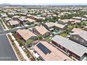An aerial view shows a neighborhood with well-maintained homes, manicured landscaping, and community amenities at 7440 E Osage Ave, Mesa, AZ 85212