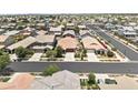 A high angle shows a neighborhood with tree-lined streets, varied architectural styles, and common green spaces at 7440 E Osage Ave, Mesa, AZ 85212