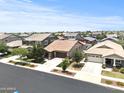 An aerial view shows a well-maintained neighborhood with landscaped yards, sidewalks and attached two car garages at 7440 E Osage Ave, Mesa, AZ 85212