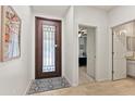 Inviting foyer featuring neutral paint, tiled floors, a decorative front door, and an open view into the house at 7440 E Osage Ave, Mesa, AZ 85212