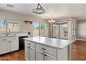 Bright kitchen featuring an island with a marble countertop and modern appliances at 7500 E Deer Valley Rd # 54, Scottsdale, AZ 85255