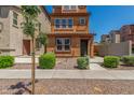 Charming three-story home featuring desert landscaping and a cozy front porch at 7732 W Bonitos Dr, Phoenix, AZ 85035